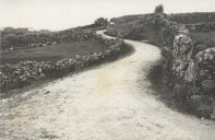 Troço da estrada entre Odrinhas e Funchal ladeada por muros de pedra solta.
