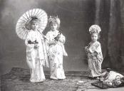 Três meninas trajadas a japonesas.